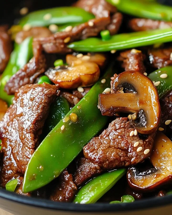 Asian beef stir-fry with mushrooms and snow peas served in a bowl
