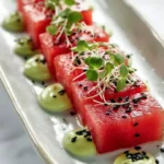 Avocado-Wasabi Cream served with Watermelon 'Tuna' on a plate