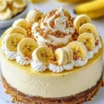 Delicious banana pudding cheesecake topped with whipped cream and banana slices.