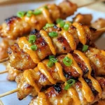 Bang Bang Chicken Skewers served on a platter with dipping sauce