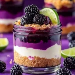 Blackberry Lime Cheesecake Jars with fresh blackberries and lime garnish