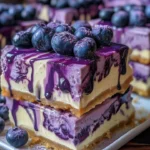 Delicious blueberry cheesecake bars with a vibrant blueberry drip on top