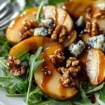 Caramelized pear and blue cheese salad with fresh greens in a bowl