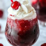 Delicious Cherry Rum and Coke Slushie in a glass with vibrant colors