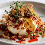 Cracked burrata served with gochujang oil and pistachio brittle