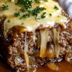 Delicious Crockpot French Onion Meatloaf topped with melted Swiss cheese