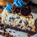 Delicious Cookie Monster Cheesecake topped with cookie crumbles and blue frosting