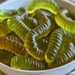 Delicious dill pickle gummy worms in a vibrant display.