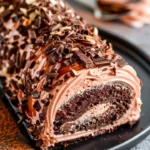 Delicious Double Chocolate Almond Caramel Cake Roll topped with caramel and almonds.