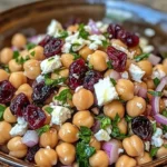 Feta and cranberry chickpeas salad with lemon vinaigrette in a bowl