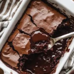 Gooey sourdough chocolate cobbler served in a bowl with a scoop of ice cream