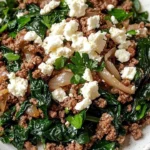 Ground beef and spinach skillet dish topped with feta cheese