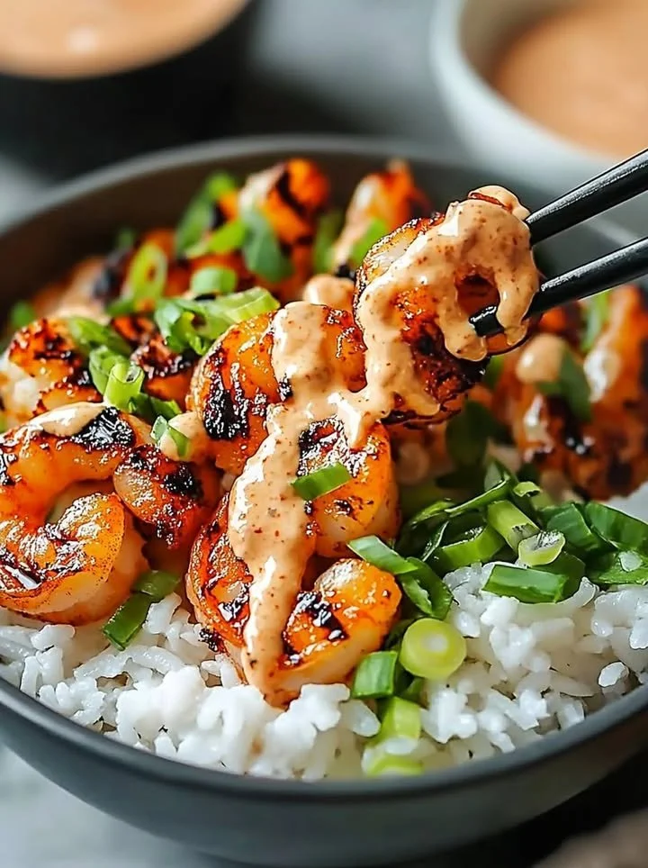 Hawaiian shrimp poke bowl garnished with sriracha mayo and fresh ingredients
