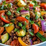 Mediterranean ground beef stir fry with colorful vegetables in a skillet
