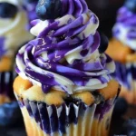 No-bake blueberry vanilla cheesecake cupcakes topped with fresh blueberries.