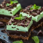 No-bake chocolate mint cheesecake bites on a graham cracker crust