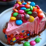 Pink Paradise No-Bake M&M and Toffee Cheesecake topped with colorful candies.