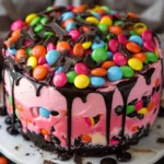 Pink Paradise No-Bake M&M Chocolate Cheesecake topped with colorful M&Ms.