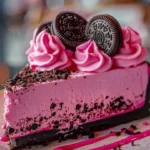 Slice of Pink Velvet Oreo Cheesecake with rich Oreo crust and creamy topping