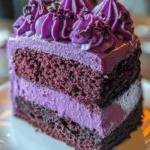 Slice of Purple Velvet Cake with cream cheese frosting on a white plate