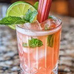 Refreshing Rhubarb Ginger Fizz cocktail with vibrant colors and garnishes.