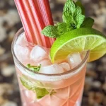 Sparkling Rhubarb Ginger Fizz cocktail served in a glass with herbs
