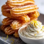 Savory Parmesan churros served with whipped burrata dip for a tasty snack.