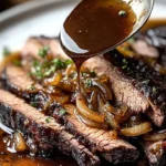 Slow cooker brisket with balsamic onion gravy served on a plate